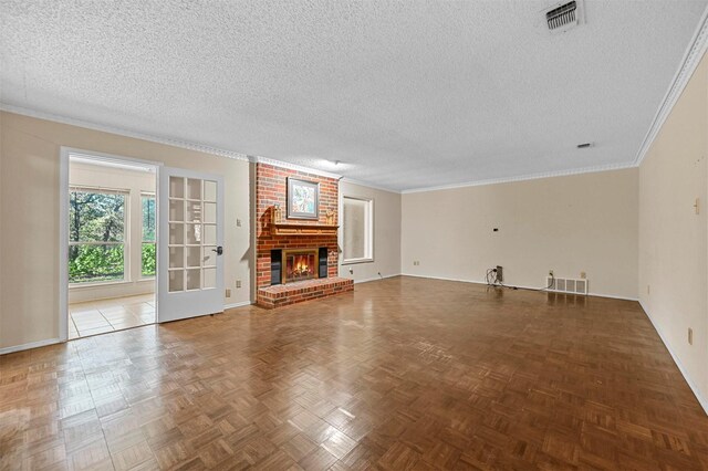 unfurnished living room featuring a fireplace, crown molding, parquet flooring, and a textured ceiling