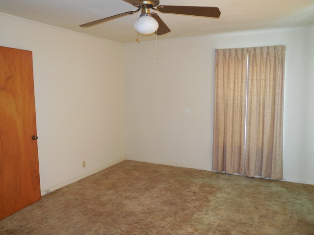 spare room featuring carpet and ceiling fan