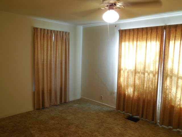 carpeted empty room featuring ceiling fan