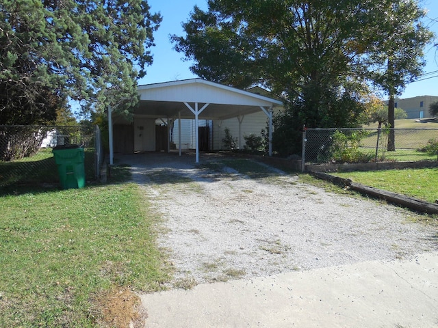 view of front of home with a front lawn and a carport