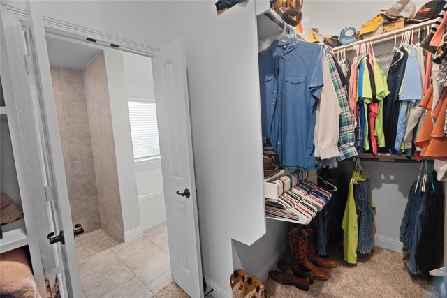 walk in closet featuring light tile patterned flooring