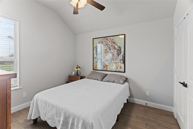 bedroom featuring a closet, ceiling fan, hardwood / wood-style floors, and vaulted ceiling