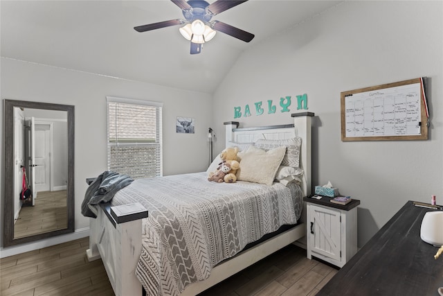 bedroom featuring hardwood / wood-style floors, ceiling fan, and lofted ceiling