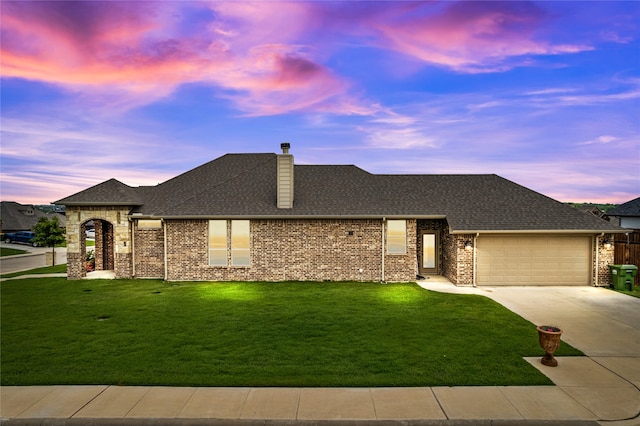 view of front of house featuring a lawn and a garage