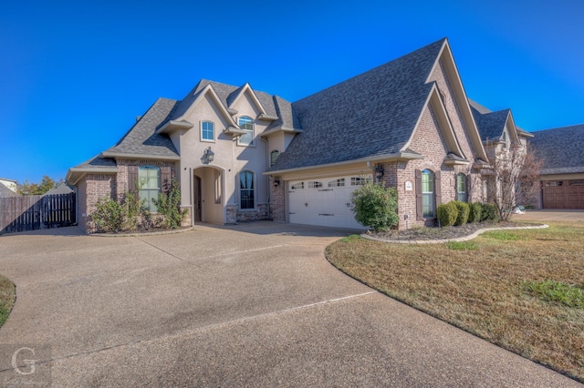 view of front of property with a garage and a front yard