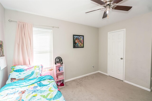 unfurnished bedroom with ceiling fan and light colored carpet