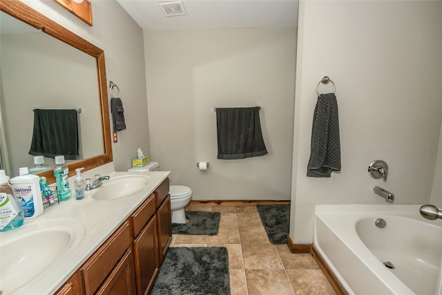 bathroom featuring tile patterned floors, a washtub, toilet, and vanity