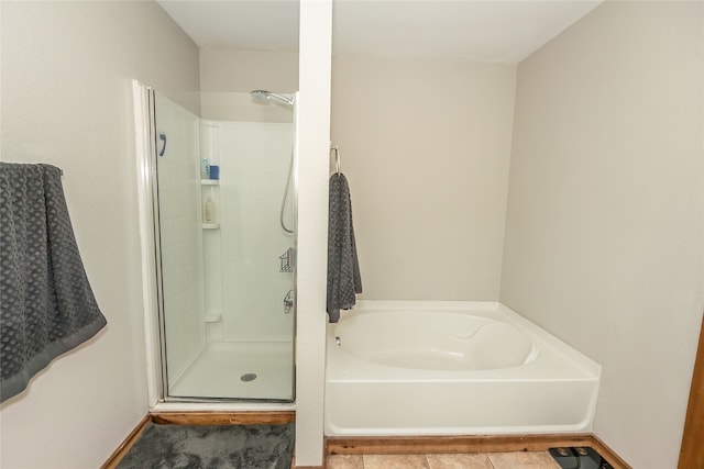 bathroom featuring shower with separate bathtub