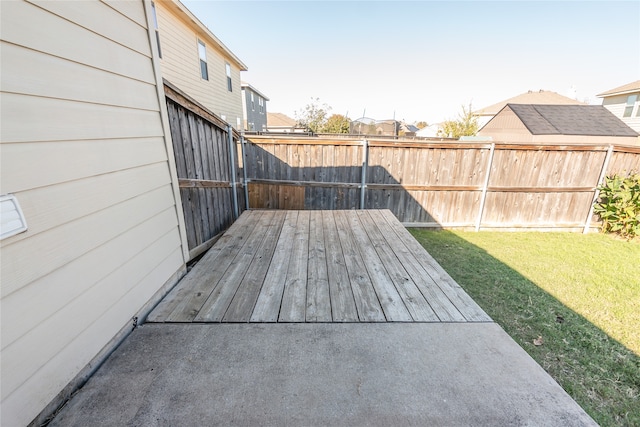 wooden deck featuring a lawn