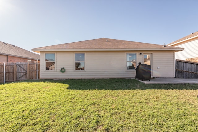 back of house with a lawn and a patio area