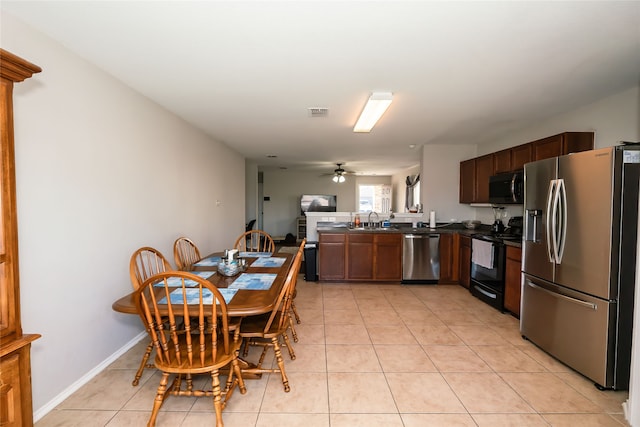 kitchen with sink, ceiling fan, light tile patterned floors, appliances with stainless steel finishes, and kitchen peninsula