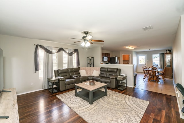 living room featuring dark hardwood / wood-style floors and ceiling fan