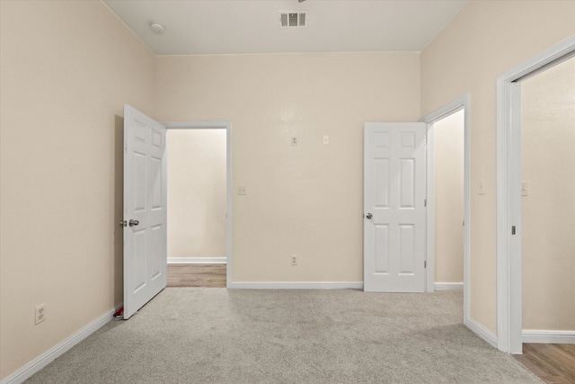 unfurnished bedroom featuring light carpet