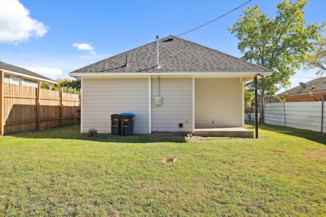 rear view of house with a lawn