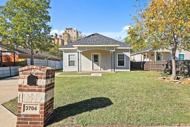 rear view of property with a porch and a yard