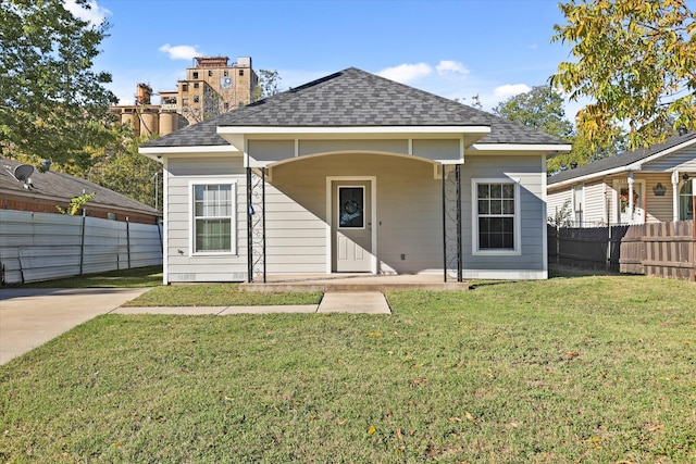 rear view of property featuring a lawn