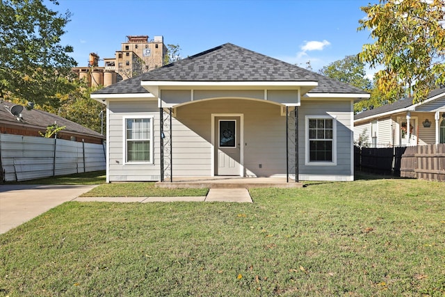 rear view of property featuring a lawn