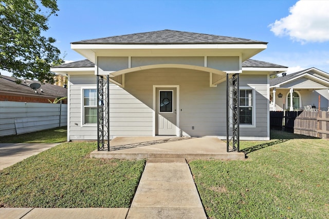 view of front of home with covered porch and a front yard