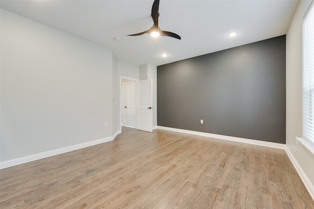 empty room featuring light wood-type flooring and ceiling fan