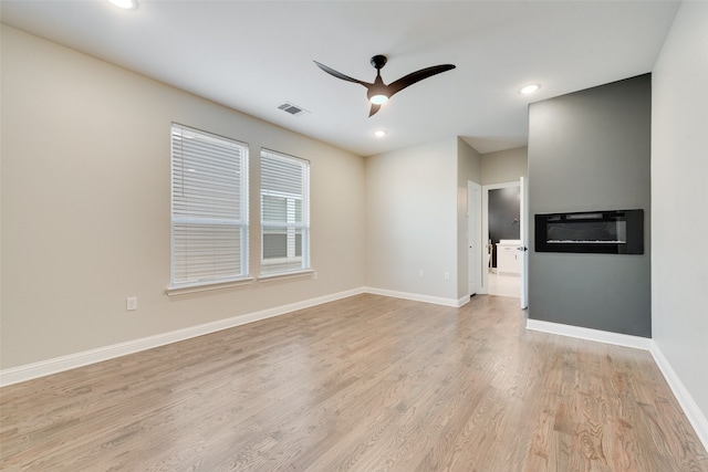 unfurnished room with ceiling fan and light hardwood / wood-style flooring