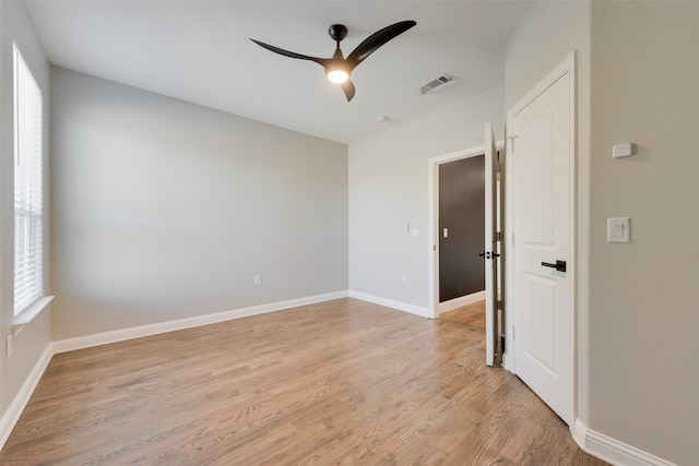 empty room with light hardwood / wood-style floors and ceiling fan