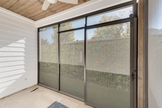 unfurnished sunroom with ceiling fan and wood ceiling