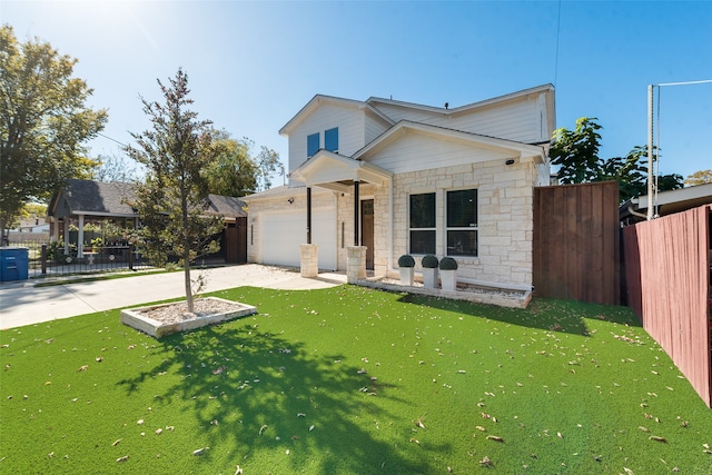 view of front of property with a front yard and a garage