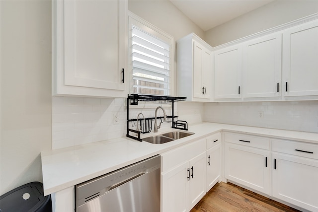 kitchen featuring dishwasher, backsplash, white cabinets, sink, and light hardwood / wood-style floors