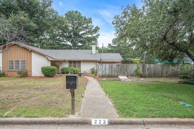 ranch-style house with a front lawn