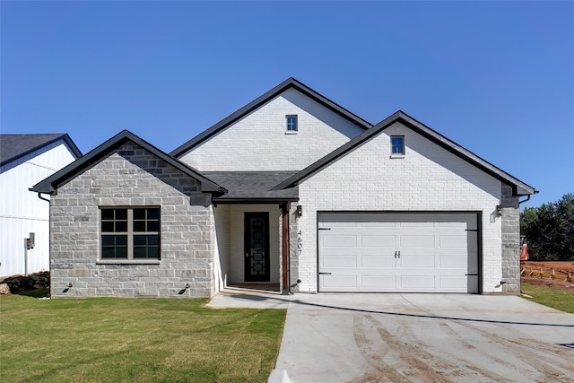 view of front facade with a front yard and a garage