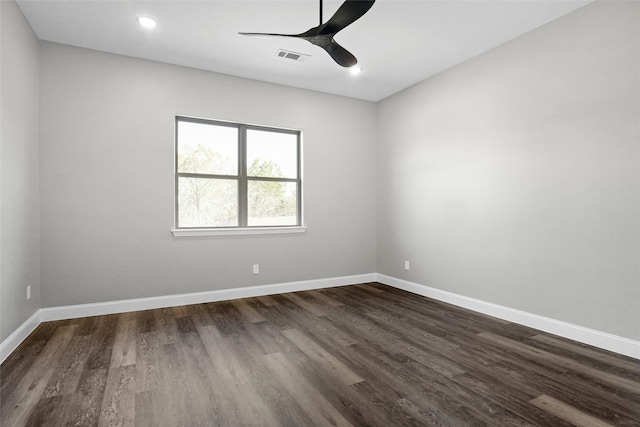 spare room with ceiling fan and dark wood-type flooring