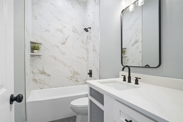 full bathroom with vanity, tiled shower / bath combo, and toilet