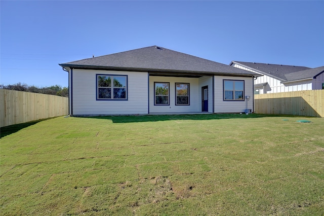 back of house featuring a lawn