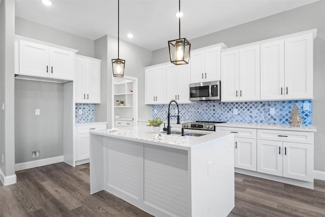 kitchen with white cabinets, pendant lighting, and appliances with stainless steel finishes