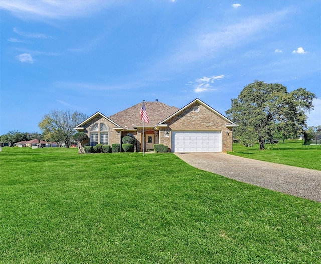 ranch-style home with a garage and a front lawn