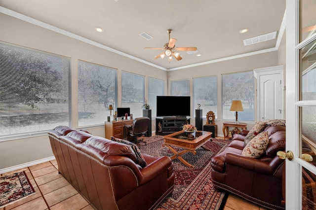 living room featuring plenty of natural light, light tile patterned flooring, and ornamental molding