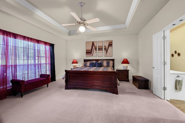 carpeted bedroom featuring a tray ceiling, ceiling fan, and crown molding