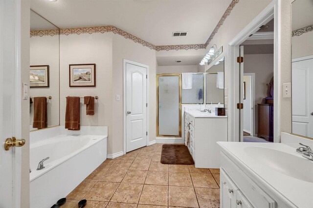 bathroom featuring tile patterned floors, vanity, and independent shower and bath