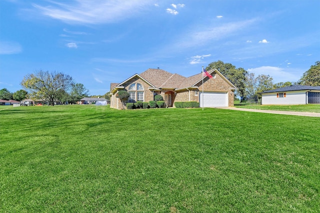 view of front of house with a garage and a front lawn