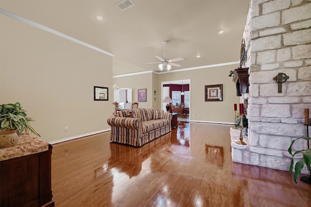 living room with hardwood / wood-style flooring, ceiling fan, and ornamental molding