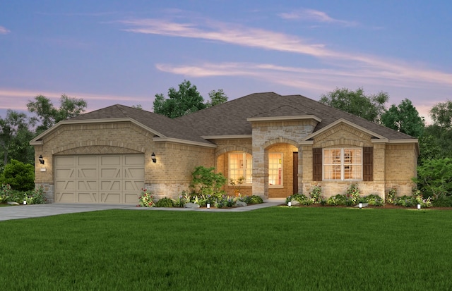 view of front of home featuring a lawn and a garage