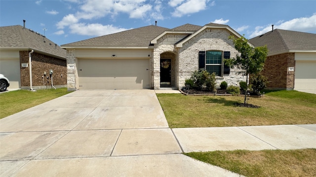 view of front of property featuring a front lawn and a garage