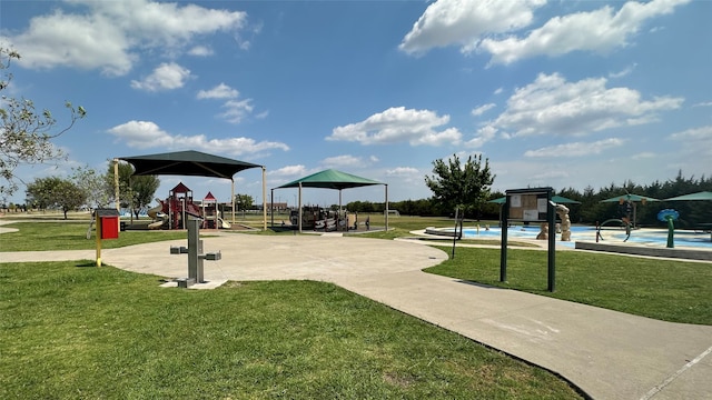 view of home's community with a playground and a yard