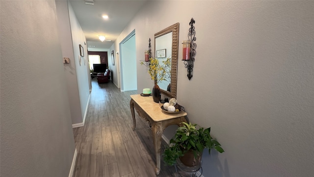 hall with hardwood / wood-style flooring