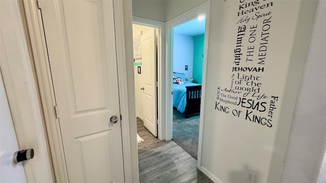 corridor with light hardwood / wood-style floors