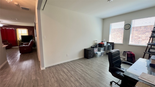 home office with hardwood / wood-style flooring and ceiling fan