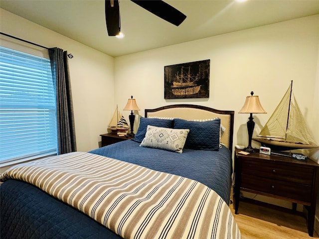 bedroom with ceiling fan and light hardwood / wood-style floors