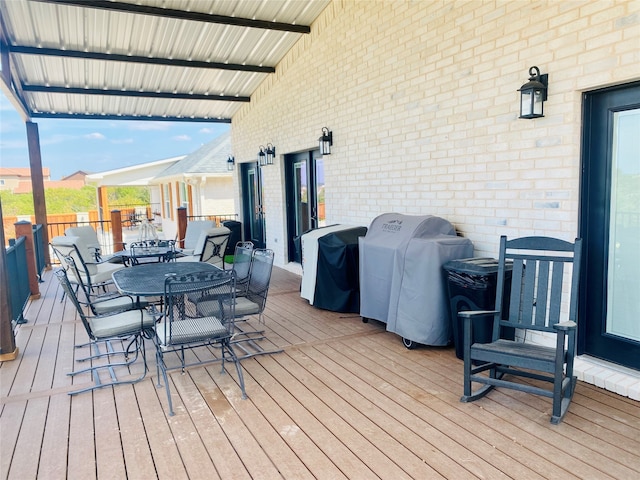 wooden terrace with a grill