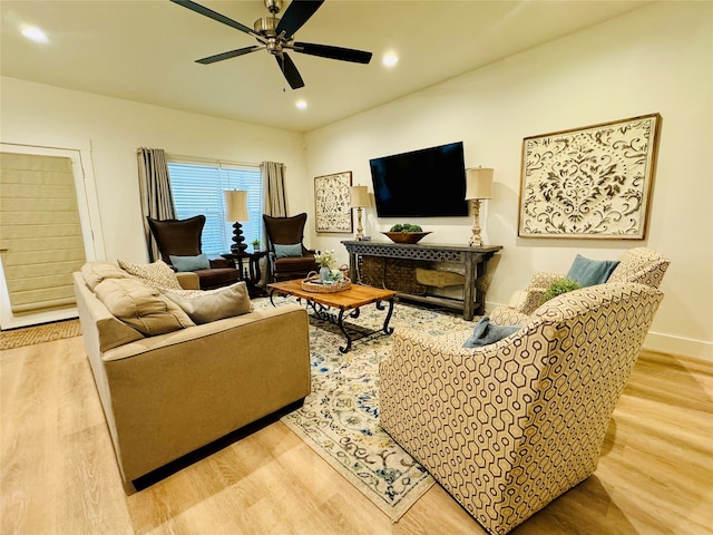 living room featuring light wood-type flooring and ceiling fan