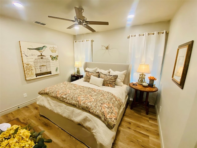 bedroom with light wood-type flooring and ceiling fan